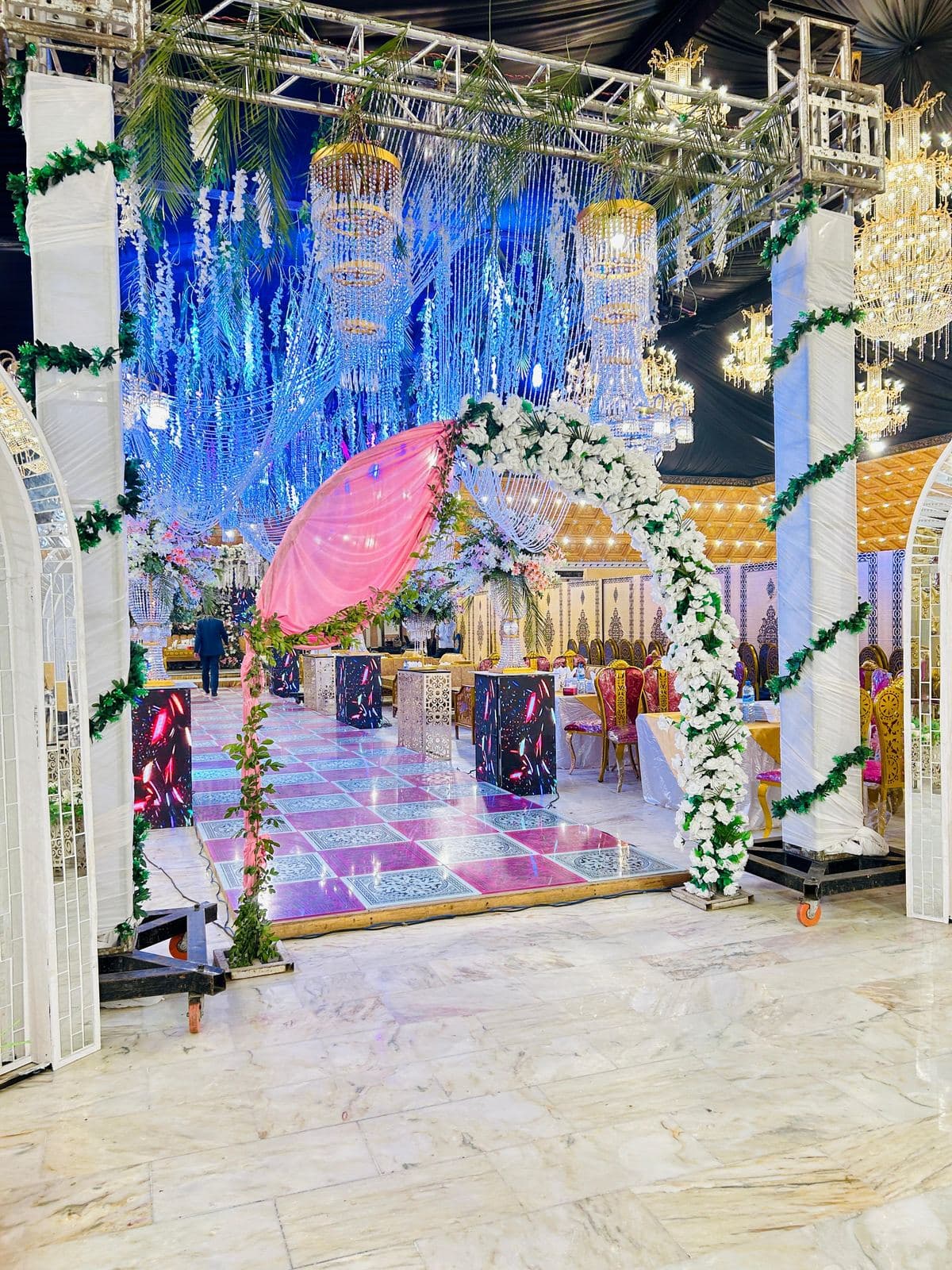 Floral arch beneath crystal chandeliers