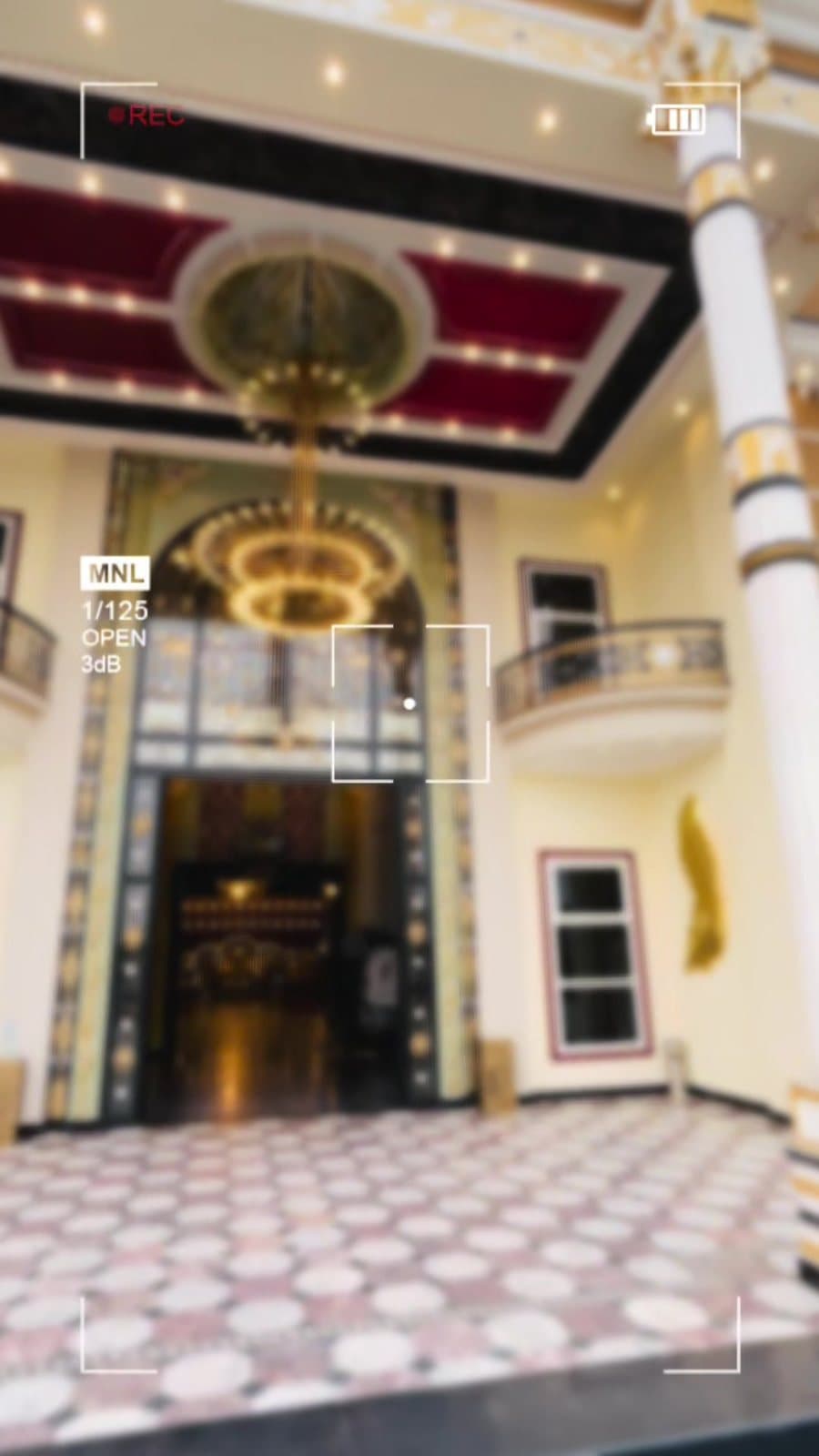 Grand Reception Lobby — Polished marble lobby with gilded ceiling chandeliers.